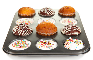 Tasty muffin cakes in baking tray isolated on white
