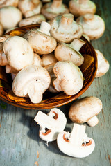 Champignon mushrooms with white variety on wooden table