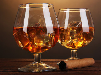 Brandy glasses with ice and cigar