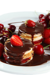 Tasty biscuit cakes with chocolate and berries