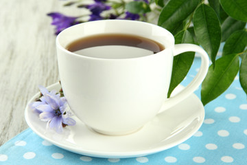 Cup of tea with chicory, on wooden background