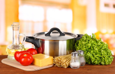 Ingredients for cooking pasta on table in kitchen