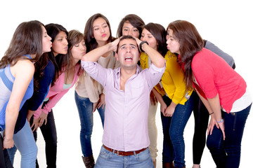 Eight Girls kissing a stressed man