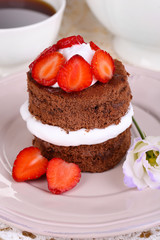 Chocolate cake with strawberry on table close-up