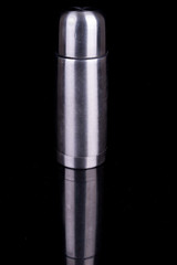 metal thermos on black background