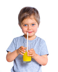 Little boy drinking orange juice