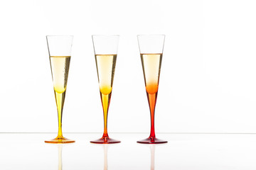 chilled champagne in colorful glasses on table