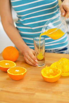 Closeup On Woman Pouring Juice Into Glass