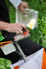 A man punching at the orienteering control point close up