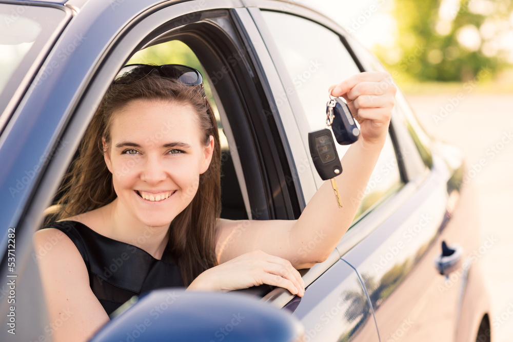 Wall mural beautiful businesswoman driving in the car