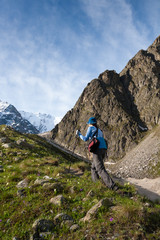 Naklejka premium Hikier is climbing mountain in Caucasus mountains in Bezengi reg