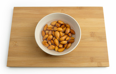 Almonds soaking in a bowl of water