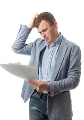 The guy looks documents and scratches a head