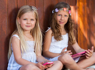 Portrait of youngsters with tablet and smart phone.