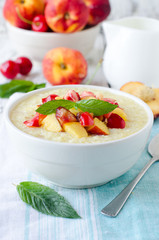 .Milk porridge with peaches and cherries