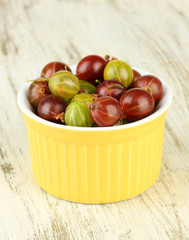 Fresh gooseberries in bowl on table close-up