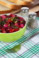 Beet salad in bowl on table close-up