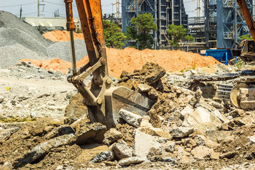 Fototapeta premium Excavator digging the concret floor