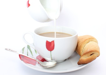 Croissant and coffee with milk on white background