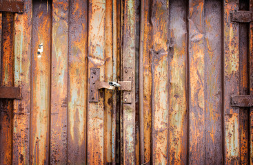 Old padlock on rusty garage collars