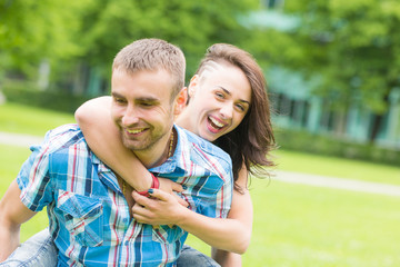 Fototapeta premium Young Couple having Piggyback Ride