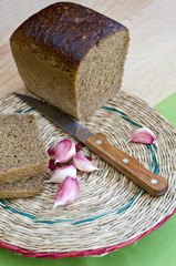 Fototapeta na wymiar The cut rye bread and garlic.