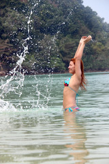 young girl in bikini bathing in the sea