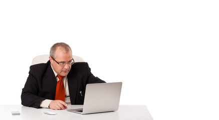 buisnessman sitting at desk and looking laptop with copy space