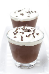 chocolate mousse with whipped cream on white background
