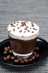 chocolate-coffee mousse with whipped cream in glass