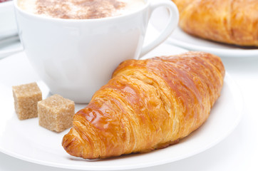 fresh croissant and cup of coffee for breakfast