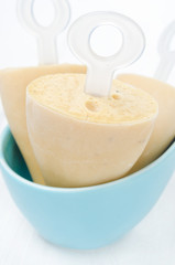 ice cream on a stick with Earl Grey tea in a bowl close-up