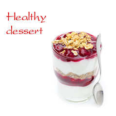 layered dessert made of yogurt, granola and cherry in a glass