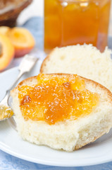 Sweet bun with apricot jam close-up, vertical