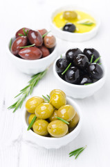 three kinds of olives, fresh rosemary and olive oil