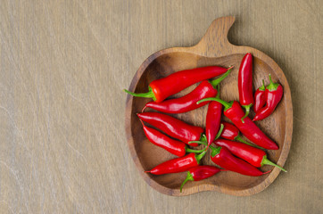 wooden bowl with red chili peppers (and space for text)