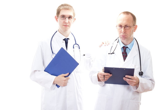 Young medical doctor cheering depressive doctor up