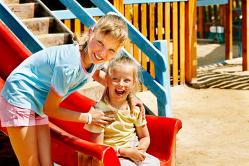 Fototapeta na wymiar Children move out to slide in playground