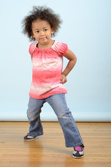 Mixed race little girl stikes a pose