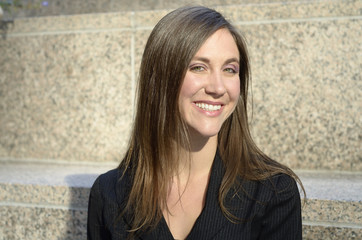 Young woman with long brown hair smiling