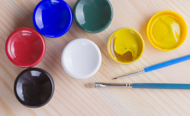 Brush and many paint jars with gouache