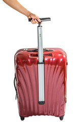 Female hand pulling red luggage bags over white background