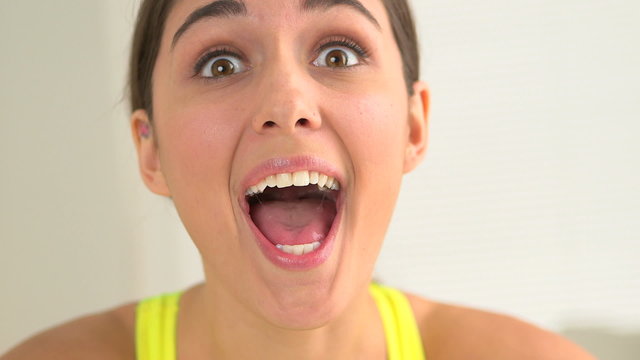 Happy smiling woman making funny faces with fruit over eyes