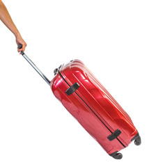 Female hand pulling red luggage bags over white background