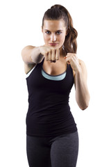 young woman in fighting stance on white background