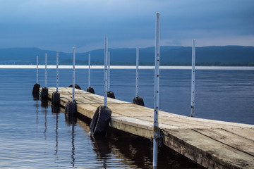 dock on lake on cloudy day