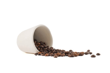 Spilled coffee beans from the cup isolated
