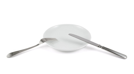 Table knife, fork and ceramic plate isolated