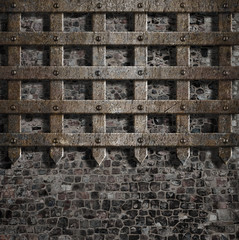 medieval old metal lattice on stone wall