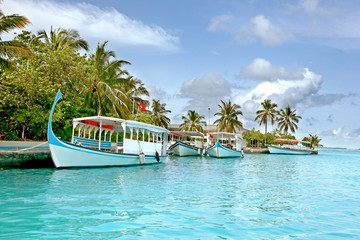 boats on a tropical resort in maldives